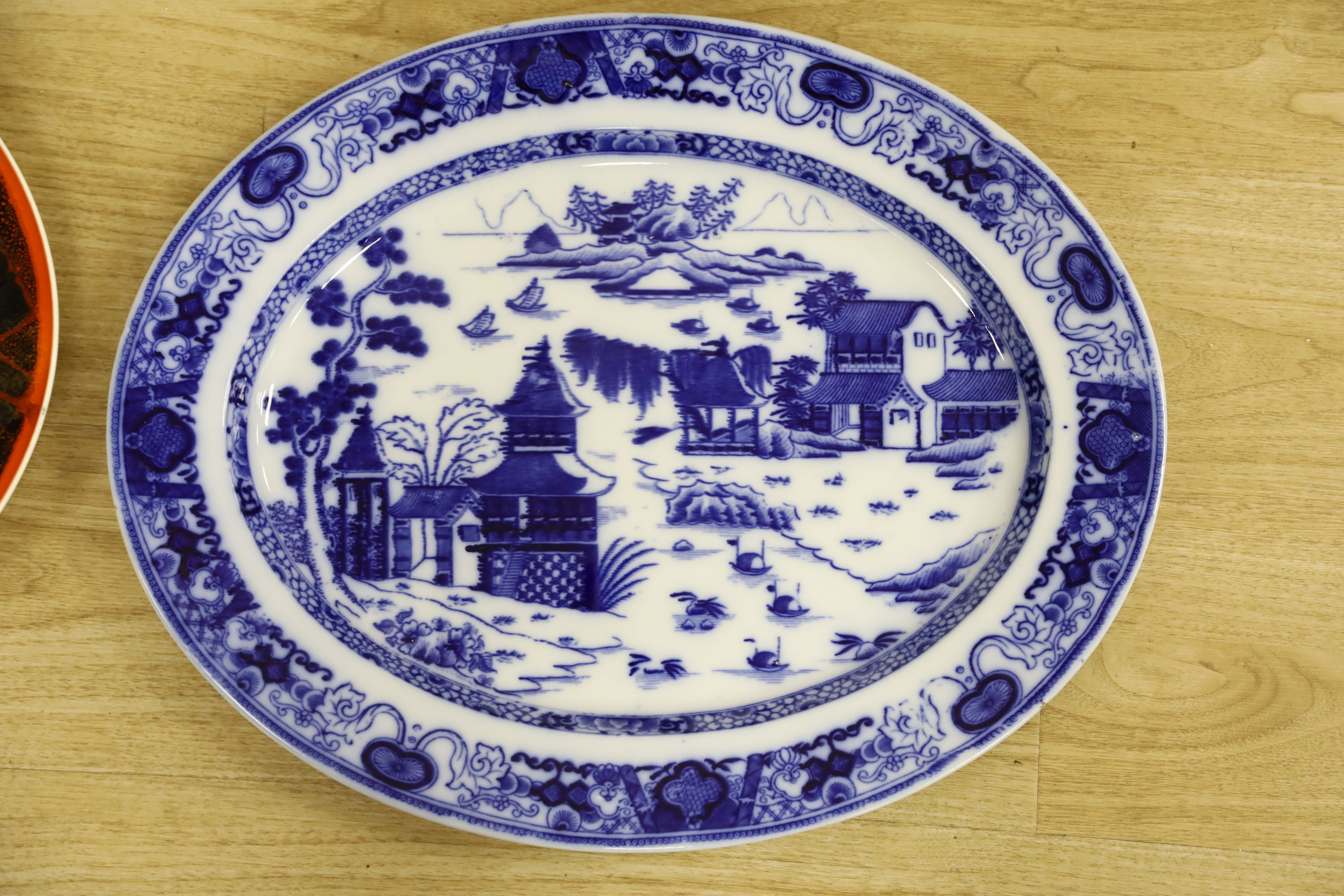A Poole pottery charger and a blue and white oval Ashworth dish, length 55cm